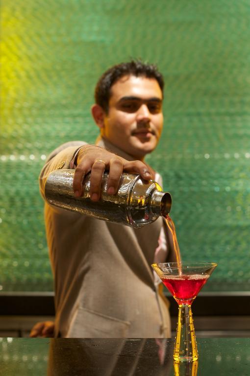 Vivanta Hyderabad, Begumpet Экстерьер фото A bartender pouring a drink